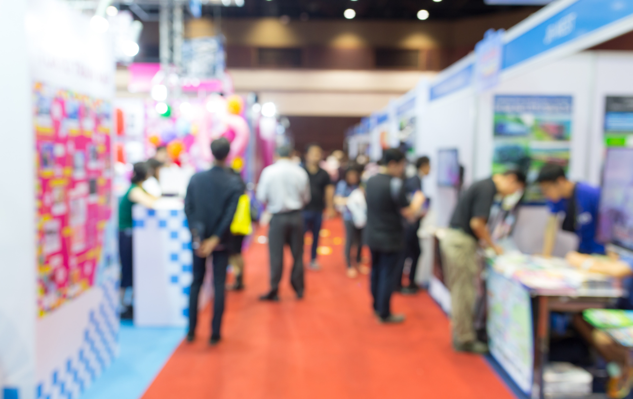 A business convention underway, with booths lined up
